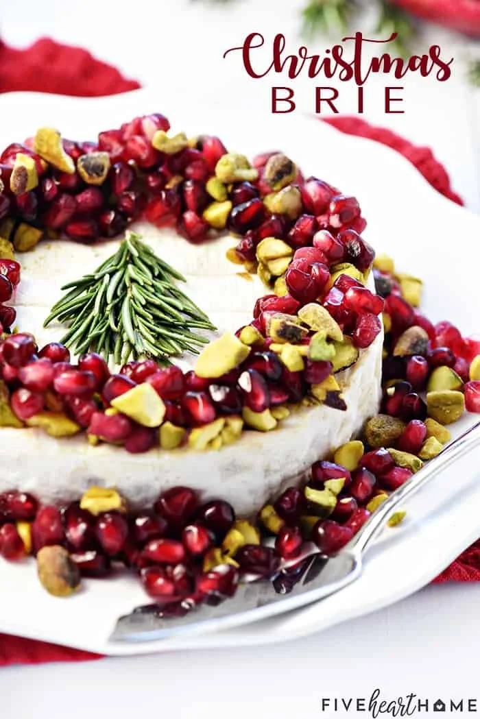 Creamy Christmas Brie topped with cranberries and nuts for a festive appetizer