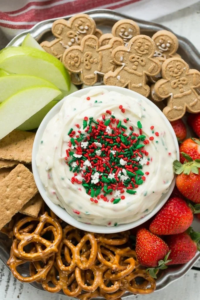 Festive Christmas cookie dough dip served in a holiday-themed bowl.