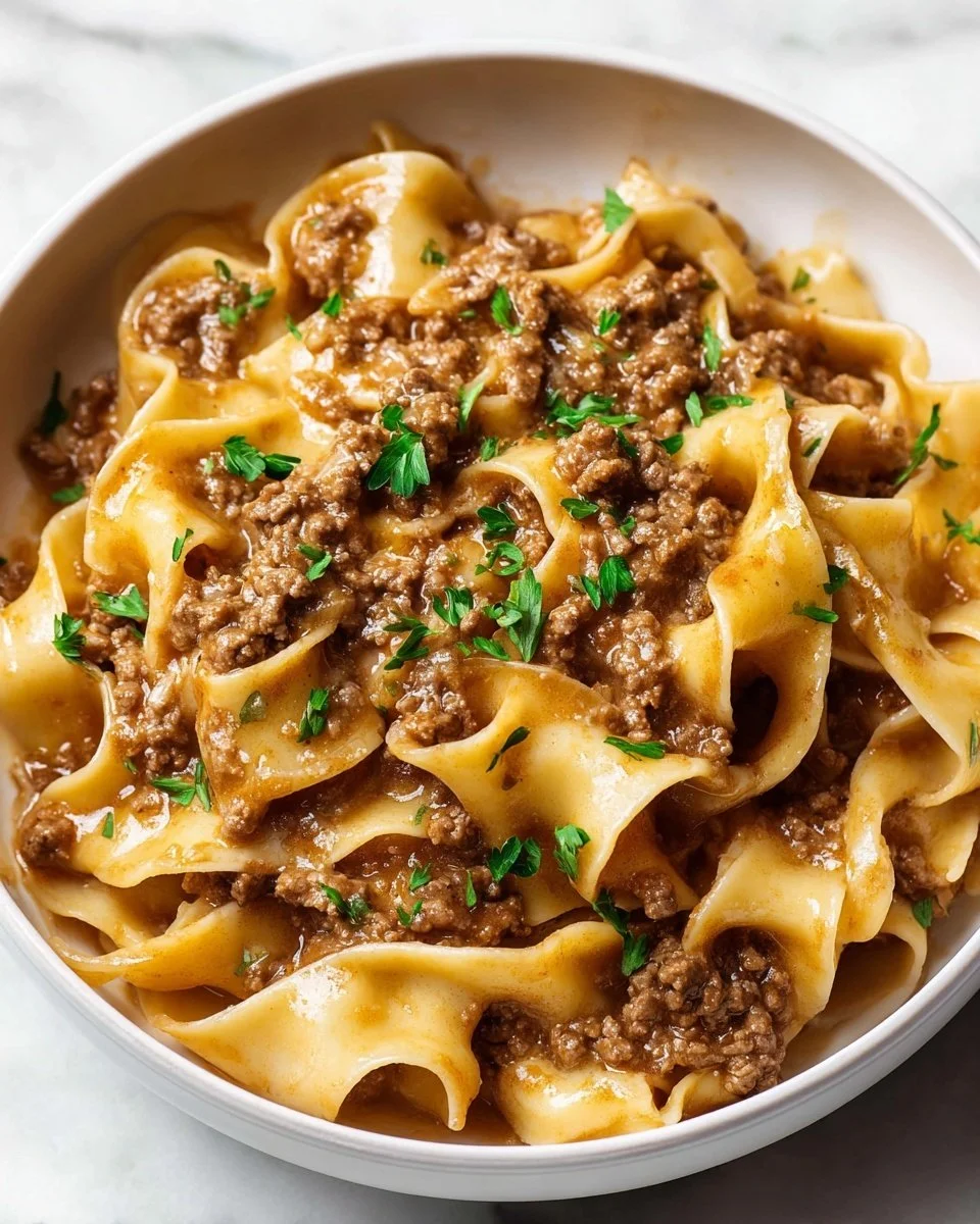Easy beef and noodles dish served in a bowl with fresh herbs.